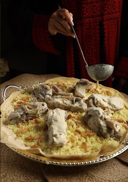 Traditional Jordanian Mansaf being served with jameed sauce in Dubai